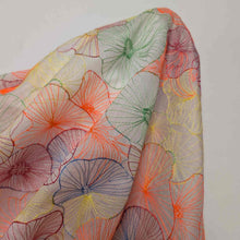 Load image into Gallery viewer, Neon embroidered tencel fabric in abstract floral shapes. Available at Minerva's Bower. Fabric draped to show how it handles