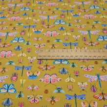 Load image into Gallery viewer, Flat lay of Thread and Ink 100% cotton, Flutter By, mustard cloth with all over butterfly dragonfly and insect print , ruler included for scale- available at Minerva's Bower
