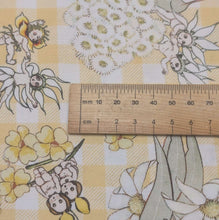 Load image into Gallery viewer, Close up flat lay of 100% Cotton, May Gibbs - Garden Playtime Yellow Gingham, ruler included for scale - for sale at Minerva's Bower