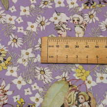 Load image into Gallery viewer, Close up flat lay of 100% Cotton May Gibbs Gumnut Gossips in Lavender, ruler included for scale - for sale at Minerva's Bower