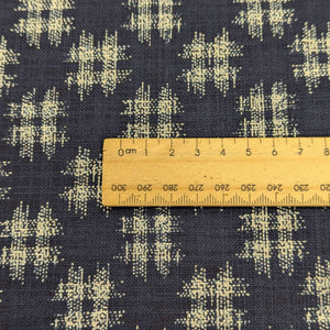 Close up of Japanese Indigo blue cotton fabric with a small natural crosshatch pattern for sale at Minerva's Bower, ruler included for scale