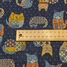 Load image into Gallery viewer, Pattern of colourful cats on a blue cotton dobby background. Made in Japan. Available at Minerva's Bower. Ruler included for scale