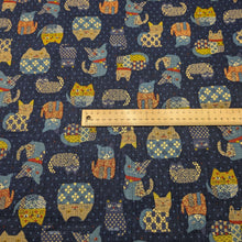 Load image into Gallery viewer, Pattern of colourful cats on a blue cotton dobby background. Made in Japan. Available at Minerva's Bower. Ruler included for scale