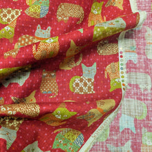 Load image into Gallery viewer, Pattern of colourful cats on a red cotton dobby background. Made in Japan. Available at Minerva's Bower. Fabric draped to show how it handles