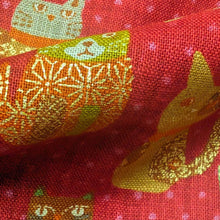 Load image into Gallery viewer, Pattern of colourful cats on a red cotton dobby background. Made in Japan. Available at Minerva's Bower. Fabric draped to show how it handles