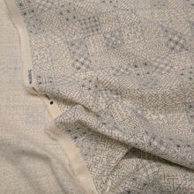 Load image into Gallery viewer, Patterned fabric with geometric sashiko design on a cream cotton background. Made in Japan. Available at Minerva's Bower. Fabric draped to show how it handles