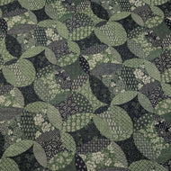 Patterned cotton fabric with green and black circles and shapes. Made in Japan. Available at Minerva's Bower