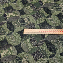 Load image into Gallery viewer, Patterned cotton fabric with green and black circles and shapes. Made in Japan. Available at Minerva's Bower. Ruler included for scale
