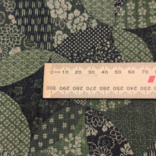 Load image into Gallery viewer, Patterned cotton fabric with green and black circles and shapes. Made in Japan. Available at Minerva's Bower. Ruler included for scale
