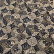 Patterned cotton fabric with circular shapes in shades of grey, brown, and blue. Made in Japan. Available at Minerva's Bower