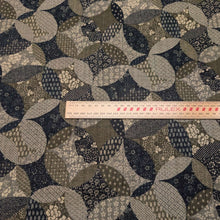 Load image into Gallery viewer, Patterned cotton fabric with circular shapes in shades of grey, brown, and blue. Made in Japan. Available at Minerva's Bower. Ruler included for scale
