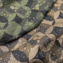 Load image into Gallery viewer, Patterned cotton fabric with circular shapes in shades of grey, brown, and blue. Made in Japan. Available at Minerva's Bower. Fabric draped to show how it handles