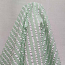 Load image into Gallery viewer, Flat lay of Joy cotton seersucker in mint colourway. Available at Minerva&#39;s Bower. Fabric draped to show scale