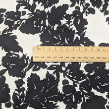 Load image into Gallery viewer, Close up of Black floral pattern cotton twill fabric with a white background, for sale at Minerva&#39;s Bower, ruler included for scale