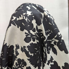 Load image into Gallery viewer, Close up of draped Black floral pattern cotton twill fabric with a white background, for sale at Minerva&#39;s Bower