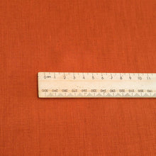 Load image into Gallery viewer, Close up of Flat lay of 100% heavyweight linen in rusty orange for sale at Minerva&#39;s Bower, ruler included for scale