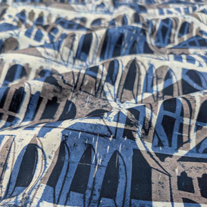 Close-up of Liberty of London fabric with abstract blue and gray pattern. Available at Minerva's Bower