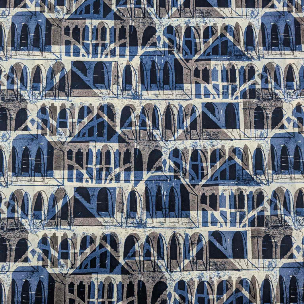Liberty of London patterned fabric with architectural design in blue, brown, and beige. Available at Minerva's Bower