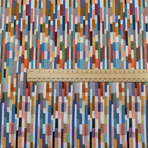 Colorful geometric patterned Liberty of London fabric with a ruler for scale. Available at Minerva's Bower