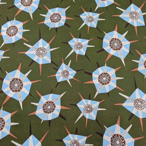 Liberty of London pattern of blue and white geometric shapes on a green background. Available at Minerva's Bower