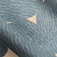 Load image into Gallery viewer, Pattern of dark grey circles on a beige cotton/linen fabric background. Made in Japan. Available at Minerva's Bower. Fabric draped to show how it handles