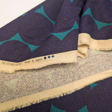Load image into Gallery viewer, Pattern of purple circles on a teal cotton /linen fabric background. Made in Japan. Available at Minerva's Bower. Fabric draped to show how it handles