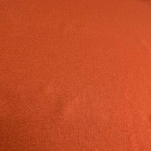 Flat lay of 100% heavyweight linen in rusty orange for sale at Minerva's Bower