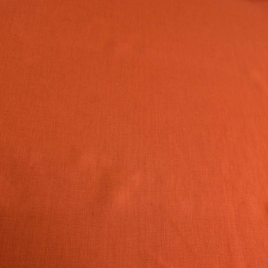 Flat lay of 100% heavyweight linen in rusty orange for sale at Minerva's Bower