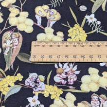 Load image into Gallery viewer, Close up of 100% Cotton, May Gibbs - Gumnut Gossiping in Black, for sale at Minerva&#39;s Bower, ruler included for scale