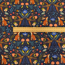 Load image into Gallery viewer, Patterned Art Gallery cotton fabric with foxes, rabbits, and flowers on a dark blue background, with a ruler for scale.