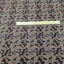 Load image into Gallery viewer, Paisley patterned burgundy lyocell fabric with a ruler for scale, for sale at Minerva&#39;s Bower