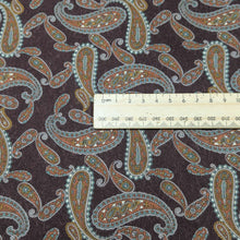 Load image into Gallery viewer, Paisley patterned burgundy lyocell fabric with a ruler for scale, for sale at Minerva&#39;s Bower