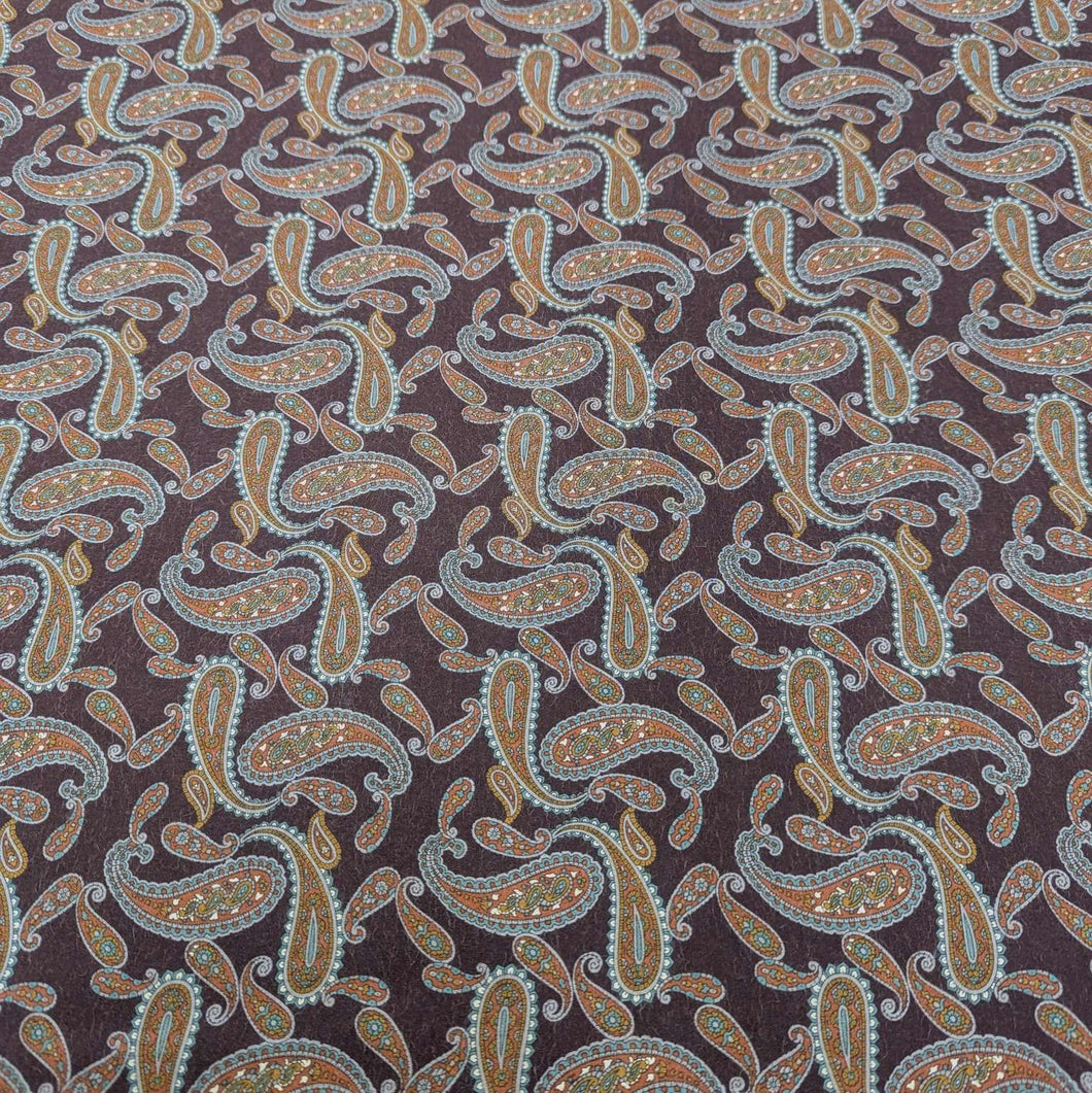 Patterned lyocell fabric with paisley design on a burgundy base, available at Minerva's Bower