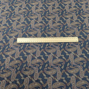 Patterned lyocell fabric with paisley design on a French Navy base, with a ruler for scale, for sale at Minerva's Bower
