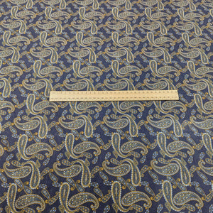 Patterned lyocell fabric with paisley design and a blue base, with a ruler for scale, for sale at Minerva's Bower