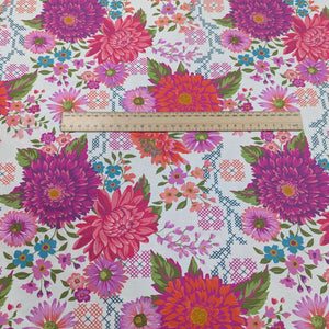 100% cotton by moda with Colourful floral pattern with pink, purple, and green flowers on a cream background, ruler included for scale