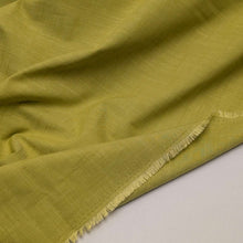 Load image into Gallery viewer, Solid green colour cotton fabricswatch with a textured pattern. Available at Minerva's Bower. Fabric draped to show how it handles