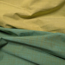 Load image into Gallery viewer, Solid green colour cotton fabricswatch with a textured pattern. Available at Minerva's Bower. Fabric draped to show how it handles. Different colourways lay side by side