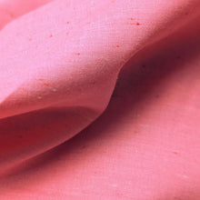 Load image into Gallery viewer, Solid pink colour cotton fabric swatch with a textured pattern. Available at Minerva's Bower. Fabric draped to show  how it handles