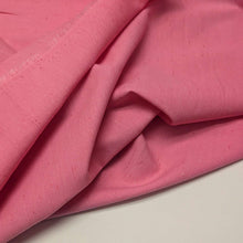 Load image into Gallery viewer, Solid pink colour cotton fabric swatch with a textured pattern. Available at Minerva's Bower. Fabric draped to show  how it handles
