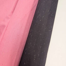 Load image into Gallery viewer, Textured dark grey background cotton fabric with small white specks. Available at Minerva's Bower. Fabric draped to show how it handles. Different colourways lay side by side