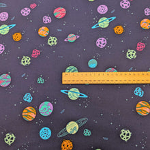 Load image into Gallery viewer, Flat lay of 100% cotton flannelette from Art Gallery Fabrics  with a pattern of colourful planets and stars on a navy base, with ruler included for scale, available at Minerva's Bower
