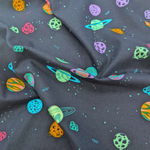 Load image into Gallery viewer, Flat drape of 100% cotton flannelette from Art Gallery Fabrics  with a pattern of colourful planets and stars on a navy base, available at Minerva's Bower