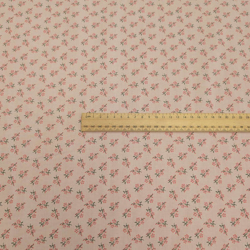 Japanese cotton fabric with a small floral pattern on a soft pink base, with ruler included for scale, for sale at Minerva's Bower