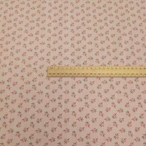 Japanese cotton fabric with a small floral pattern on a soft pink base, with ruler included for scale, for sale at Minerva's Bower