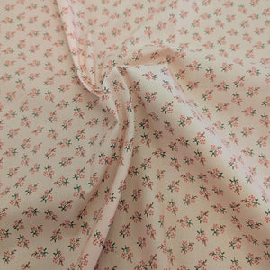 Drape of Japanese cotton fabric with a small floral pattern on a soft pink base, for sale at Minerva's Bower