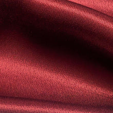 Load image into Gallery viewer, A close-up of a red viscose twill satin fabric surface, our Prom Viscose in Claret. Available at Minerva's Bower. Fabric draped to show how it handles