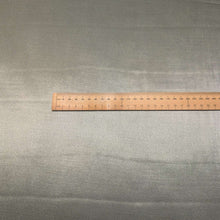 Load image into Gallery viewer, A close-up of a sage viscose twill satin fabric, Prom Viscose in Lichen. Available at Minerva's Bower. Ruler included for scale