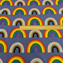 Load image into Gallery viewer, Alexander Henry cotton Fabric with rainbow pattern on a blue background, for sale at Minerva&#39;s Bower, ruler included for scale