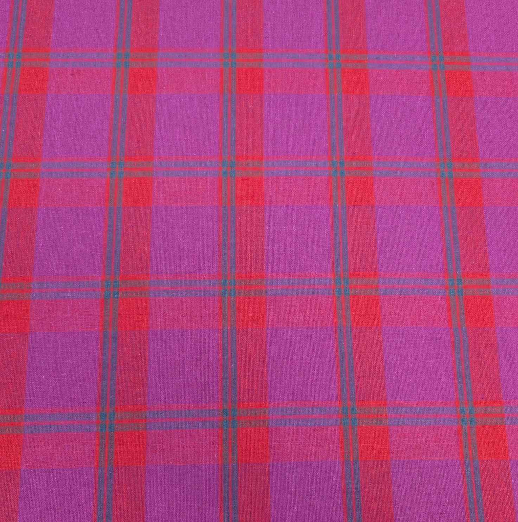 Flat lay of linen cotton Raspberry Plaid in red, pink and purple. Available at Minerva's Bower